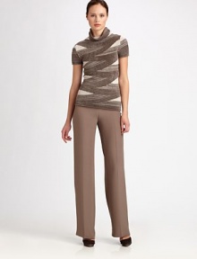 Luxuriously soft chenille, knit in a criss-crossing bandage pattern with a turtleneck collar.TurtleneckShort sleeves47% viscose/27% wool/26% polyamideDry cleanMade in Italy of imported fabricModel shown is 5'10½ (177cm) wearing US size 4. Luxuriously soft chenille, knit in a criss-crossing bandage pattern with a turtleneck collar.TurtleneckShort sleeves47% viscose/27% wool/26% polyamideDry cleanMade in Italy of imported fabricModel shown is 5'10½ (177cm) wearing US size 4.