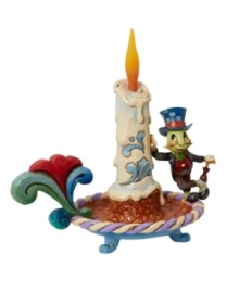 The lovable Disney character Jiminy Cricket leans against an ornately decorated candle. Jim Shore's take on the classic animated character detailed with festive touches makes it a great holiday gift.