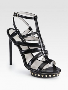 Head-turning leather silhouette with edgy metal studs, a powerful island platform and adjustable slingback strap. Lacquered heel, 5 (125mm)Studded island platform, 1 (25mm)Compares to a 4 heel (100mm)Studded leather upperAdjustable slingback strapLeather liningLeather and rubber solePadded insoleMade in Italy