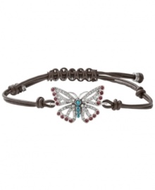 Fashionably fluttering. Fossil's free-spirited butterfly bracelet features purple and clear-colored crystals, reconstituted turquoise, and a chocolate leather adjustable wrist wrap. Set in silver tone mixed metal. Approximate diameter: 2-1/2 inches.