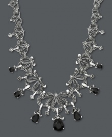 Please do elaborate. Your neckline will shine when adorned with Genevieve & Grace's unique, scrolling necklace. Pear-cut onyx (11-3/4 ct. t.w.) and glittering marcasite create an ultra-dramatic look. Crafted in sterling silver. Approximate length: 18 inches. Approximate drop: 9/16 inch. Please do elaborate. Your neckline will shine when adorned with Genevieve & Grace's unique, scrolling necklace. Pear-cut onyx (11-3/4 ct. t.w.) and glittering marcasite create an ultra-dramatic look. Crafted in sterling silver. Approximate length: 18 inches. Approximate drop: 9/16 inch.