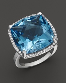 A cushion cut blue topaz is framed by diamonds in this sparkling 18K white gold ring from Lisa Nik's Rocks Collection. A cushion cut blue topaz is framed by diamonds in this sparkling 18K white gold ring from Lisa Nik's Rocks Collection.