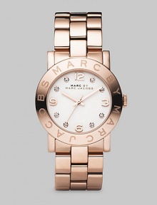 A glowing and sparkling timepiece with a polished IP rose gold finish over stainless steel and a bold link bracelet. Precision quartz movement Water-resistant to 3ATM Signature bezel Round stainless steel case; 36mm diameter (1.42) White dial Arabic numerals and rhinestone hour markers Second hand Link bracelet; 20mm wide (.79) Imported 