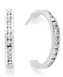 Traditions gives a sparkling boost to a simple pair of hoop earrings. A channel-set row of round-cut crystal with Swarovski elements shines within a sterling silver setting. Earrings feature a post and stud backing. Approximate diameter: 3/4 inch.