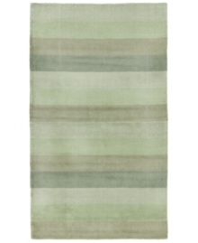 Hand-tufted, blended wool gives an exceptionally soft feel to this rug from the Coastal Treasures collection. In a shimmering, striped design of moss-green colorways, this sophisticated piece adds serene character to every decor.