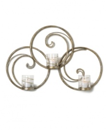 Equal parts wall art and lighting solution, the Symphony Swirl Ring sconce by Mikasa illuminates a room with a festive twist. Featuring whimsical swirls of goldtone metal and glass candle holders wrapped in shimmering ribbons.