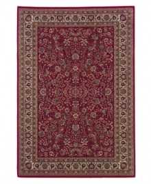 Inspired by the lovely Sarouk carpets of ancient Persia, this rug features an intricate floral motif in ivory, sage green and accents of soft blue against a rich red ground.