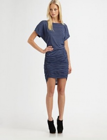 Sporty horizontal stripes add a nautical touch to this edgy, side-zip design.BoatneckShort dolman sleevesRuched skirt with asymmetric side zipAbout 17½ from natural waist70% rayon/30% lyocellDry cleanImported