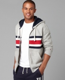 A dose of nostalgia in a bold bar stripe, this Tommy Hilfiger hoodie shows an iconic trio of hues. A dose of nostalgia in a bold bar stripe, this Tommy Hilfiger hoodie shows an iconic trio of hues.