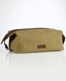 An impeccably stylish carrying case for the modern gentleman, this lightweight pouch provides sharp transport for essential toiletries in a leather-trimmed canvas construction.