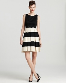 Brimming with ladylike charm, this kate spade new york dress showcases statement stripes atop a pleated skirt for retro-chic appeal.