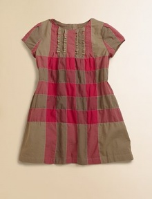 An updated check, delicately detailed with pintucking and tiny ruffles.Round necklineShort sleeves with pleating at the shouldersPintucked bodice, front and backFront rufflesBack zipperSlightly flared shape97% cotton/2% nylon/1% elastaneMachine washImported An updated check, delicately detailed with pintucking and tiny ruffles.Round necklineShort sleeves with pleating at the shouldersPintucked bodice, front and backFront rufflesBack zipperSlightly flared shape97% cotton/2% nylon/1% elastaneMachine washImported