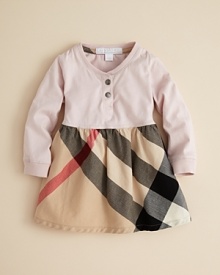 This henley dress blends a soft jersey upper with a knit ruffled skirt rendered in Burberry's signature check print. This henley dress blends a soft jersey upper with a knit ruffled skirt rendered in Burberry's signature check print.
