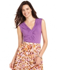 Jones New York's basic petite top is dressed up with a flattering crisscross detail at the chest and an of-the-moment color. Pair it with a printed skirt for an effortless ensemble. Jones New York's basic petite top is dressed up with a flattering crisscross detail at the chest and an of-the-moment color. Pair it with a printed skirt for an effortless ensemble.