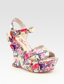 A secure slingback and adjustable ankle strap add comfort to this chic floral-printed patent leather contoured wedge. Self-covered wedge, 4¾ (120mm)Covered platform, 1½ (40mm)Compares to a 3¼ heel (80mm)Patent leather upperLeather liningRubber trek solePadded insoleMade in ItalyOUR FIT MODEL RECOMMENDS ordering one size up as this style runs small. 